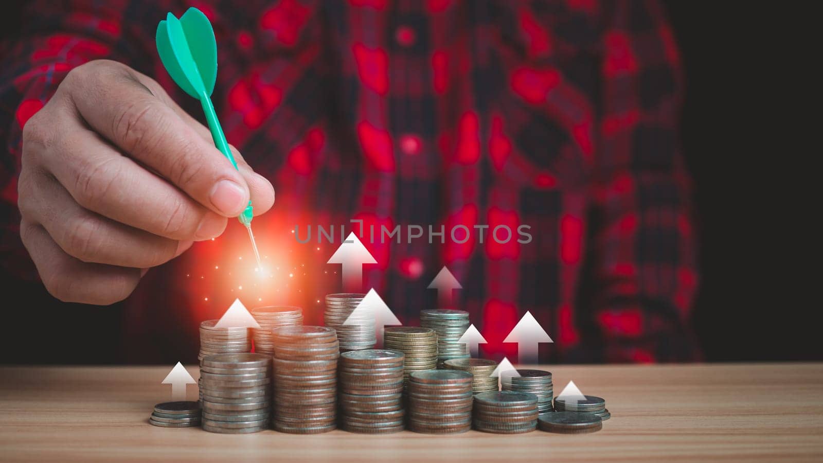 Businessman uses arrows to mark income goals, financial goals, savings goals, retirement financial goals. by Unimages2527