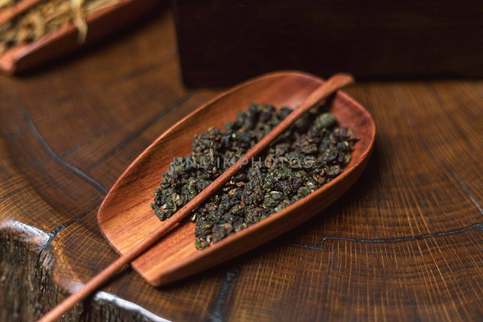 An elegantly arranged collection of herbal tea leaves beautifully displayed in a wooden tray, showcasing natural beauty