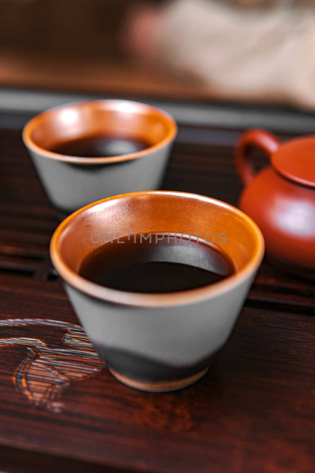 A collection of exquisite tea cups and a crafted teapot celebrate the essence of traditional tea culture