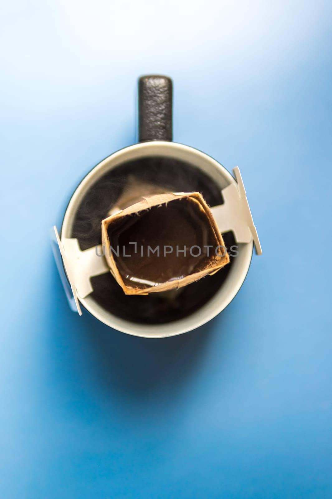 An overhead photo highlights the intricate process of brewing coffee with a dripper and a stylish mug