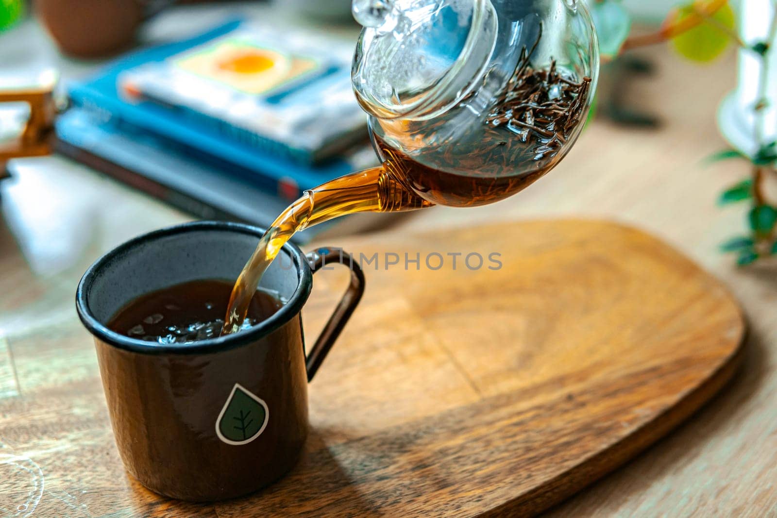 A warm and inviting scene of tea being poured delicately into a cup, creating a lovely cozy ambiance