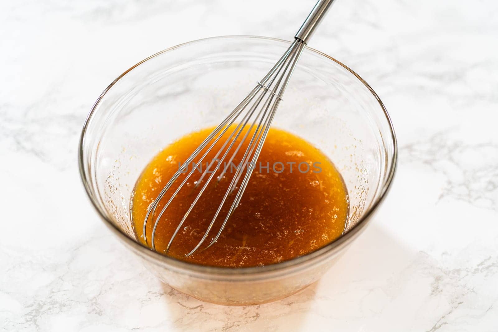 Wet ingredients including maple syrup and two eggs in a glass bowl for Pale Gingerbread Cookies. Ready for mixing.
