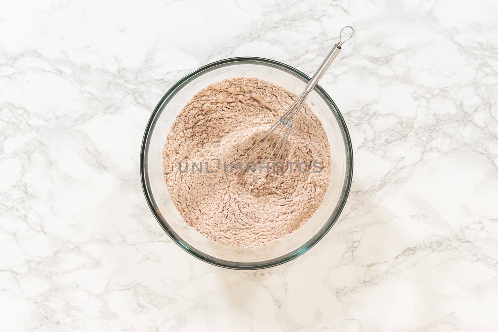 Top view of a bowl containing flour and spices for Chocolate Ginger Sugar Cookie Dough, highlighting key ingredients like ginger and cocoa powder.