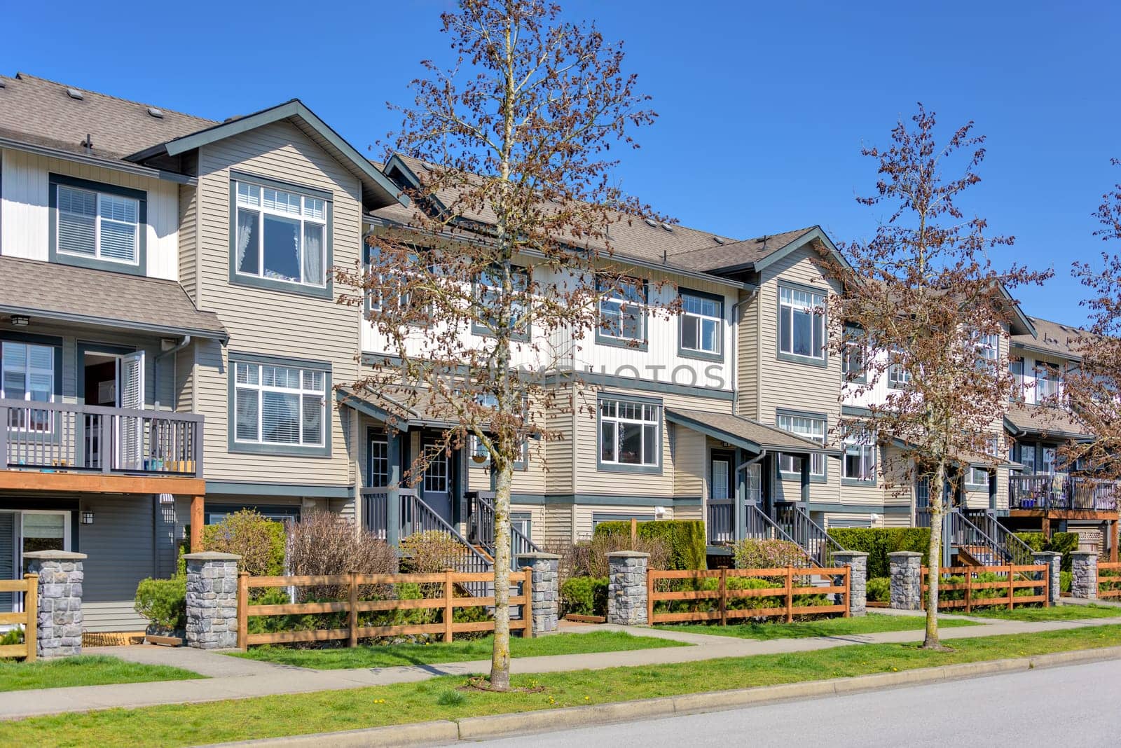 Street of residential townhouses on bright spring day in British Columbia, Canada.