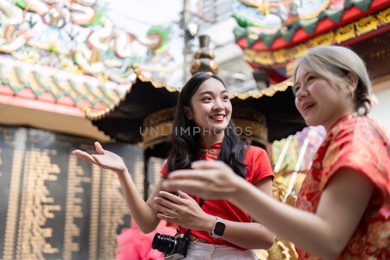 Two friends share laughter and stories during Chinese New Year festivities embodying joy and cultural connection.