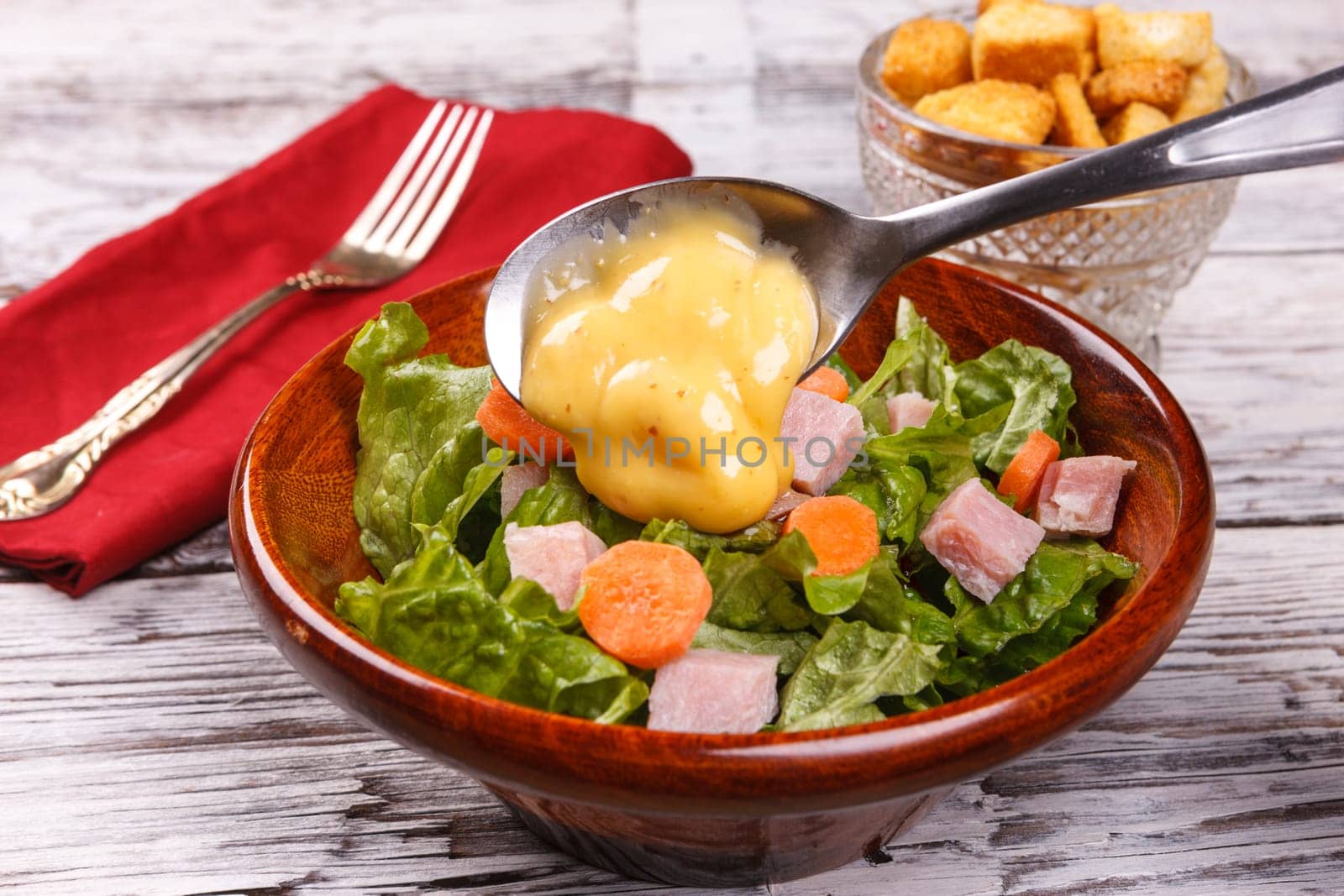Close up of a delicious salad with honey mustard dressing.