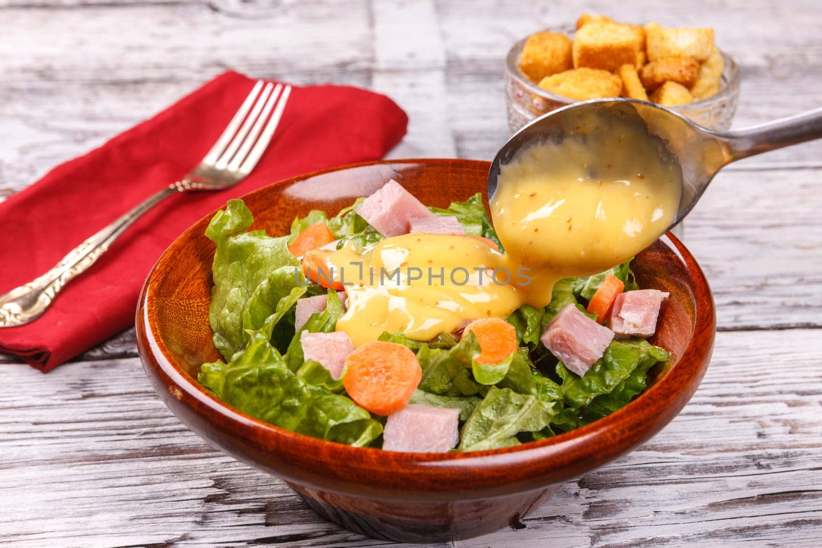 Close up of a delicious salad with honey mustard dressing.