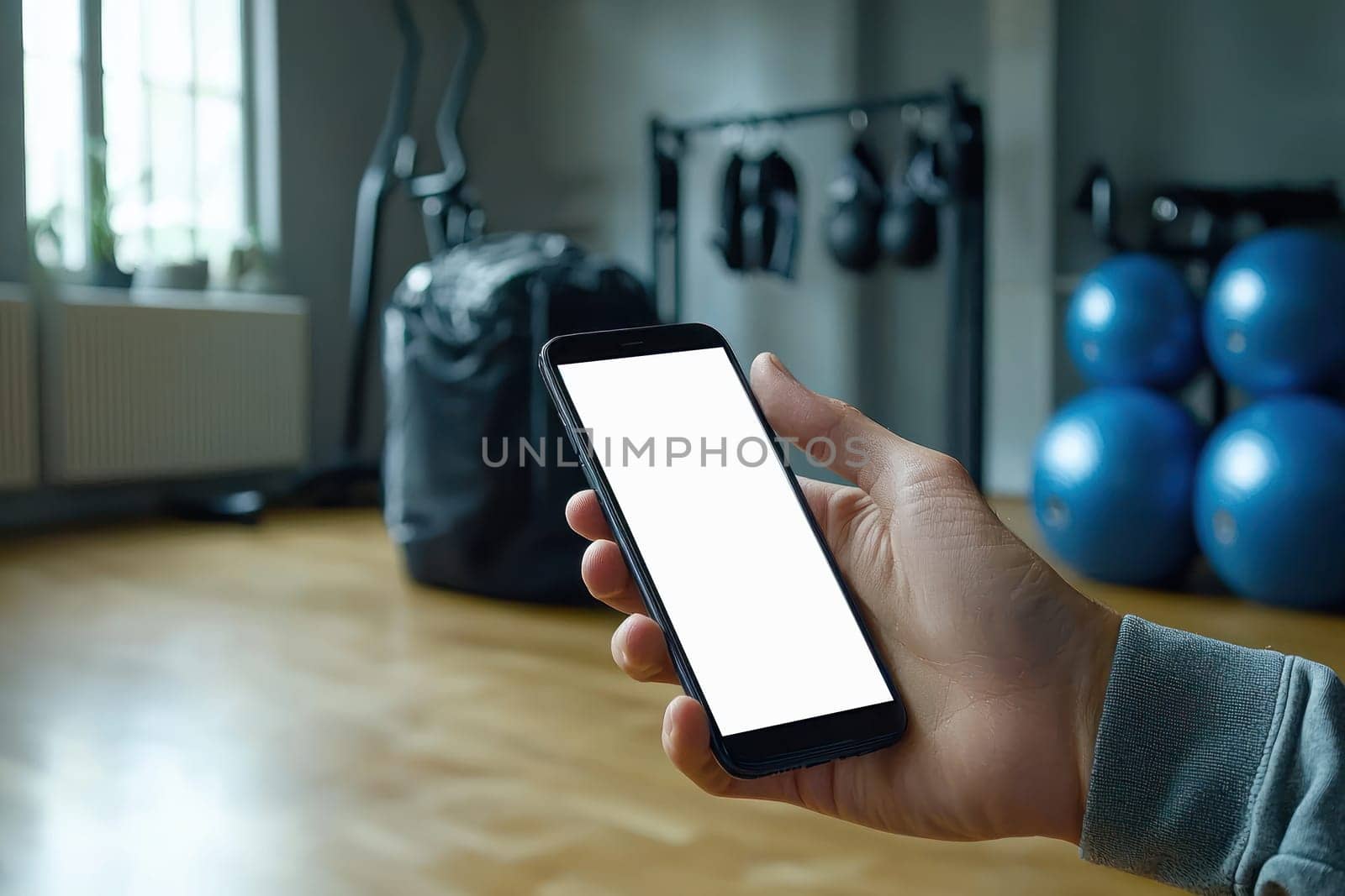 A young man holds smartphone in gym, ready to track his fitness progress. atmosphere is motivating and energetic