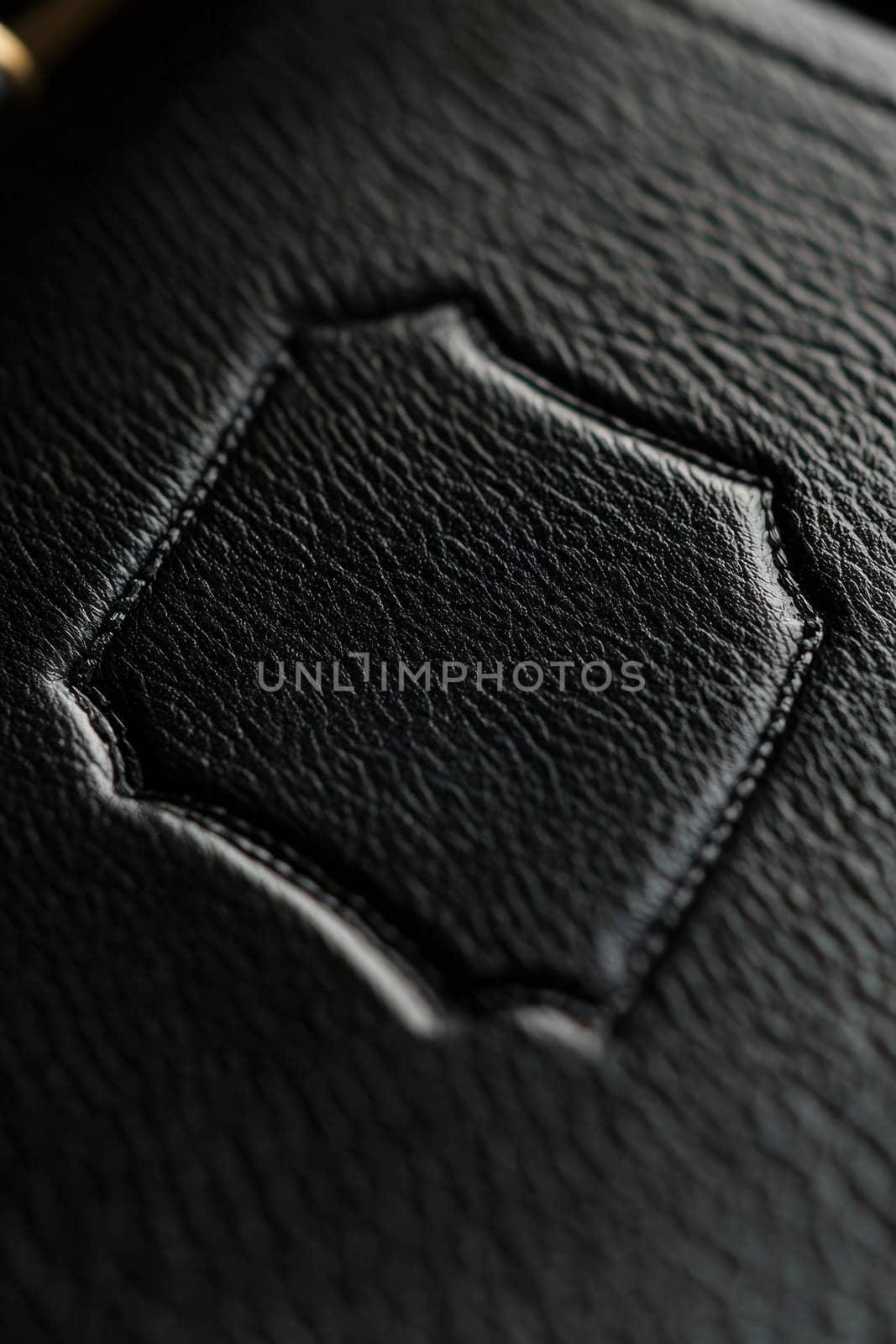 A detailed view of a vinyl sticker featuring a sophisticated monogram applied to a matte leather journal. soft lighting enhances the luxurious texture, suitable for elegant stationery branding and design work.