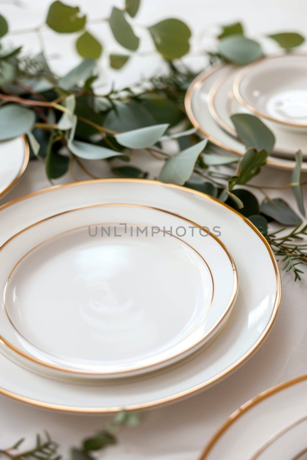 A sophisticated table arrangement featuring mocha mousse dining plates with gold rims on a sleek white dining table. complemented by decorative greenery, the scene blends contemporary style with classic elegance for upscale dining experiences.