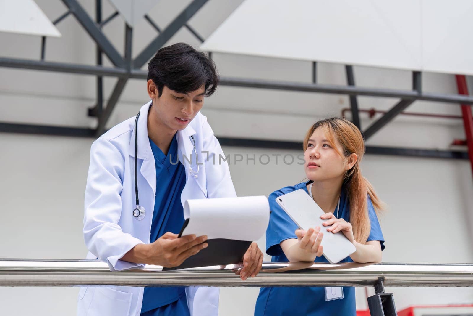 A healthcare team collaborates in a hospital discussing patient care strategies to enhance treatments and outcomes.