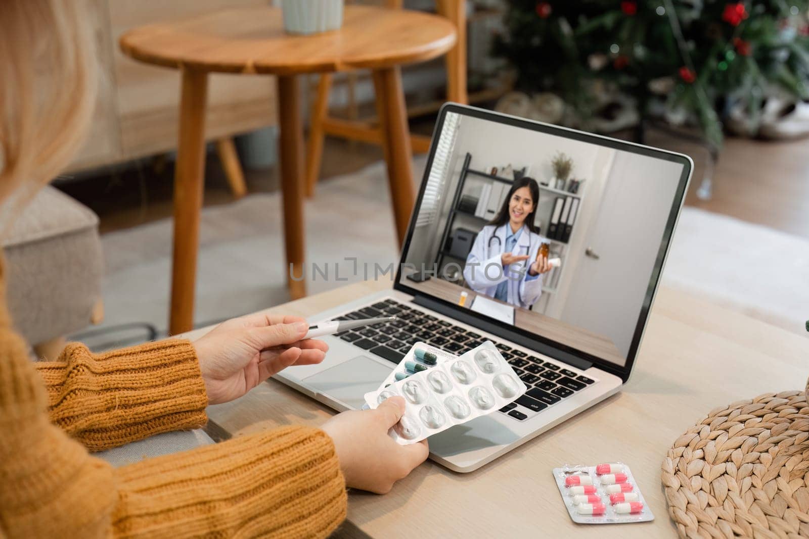 A female doctor offers health advice online through a video call, showcasing modern telemedicine in a home environment.