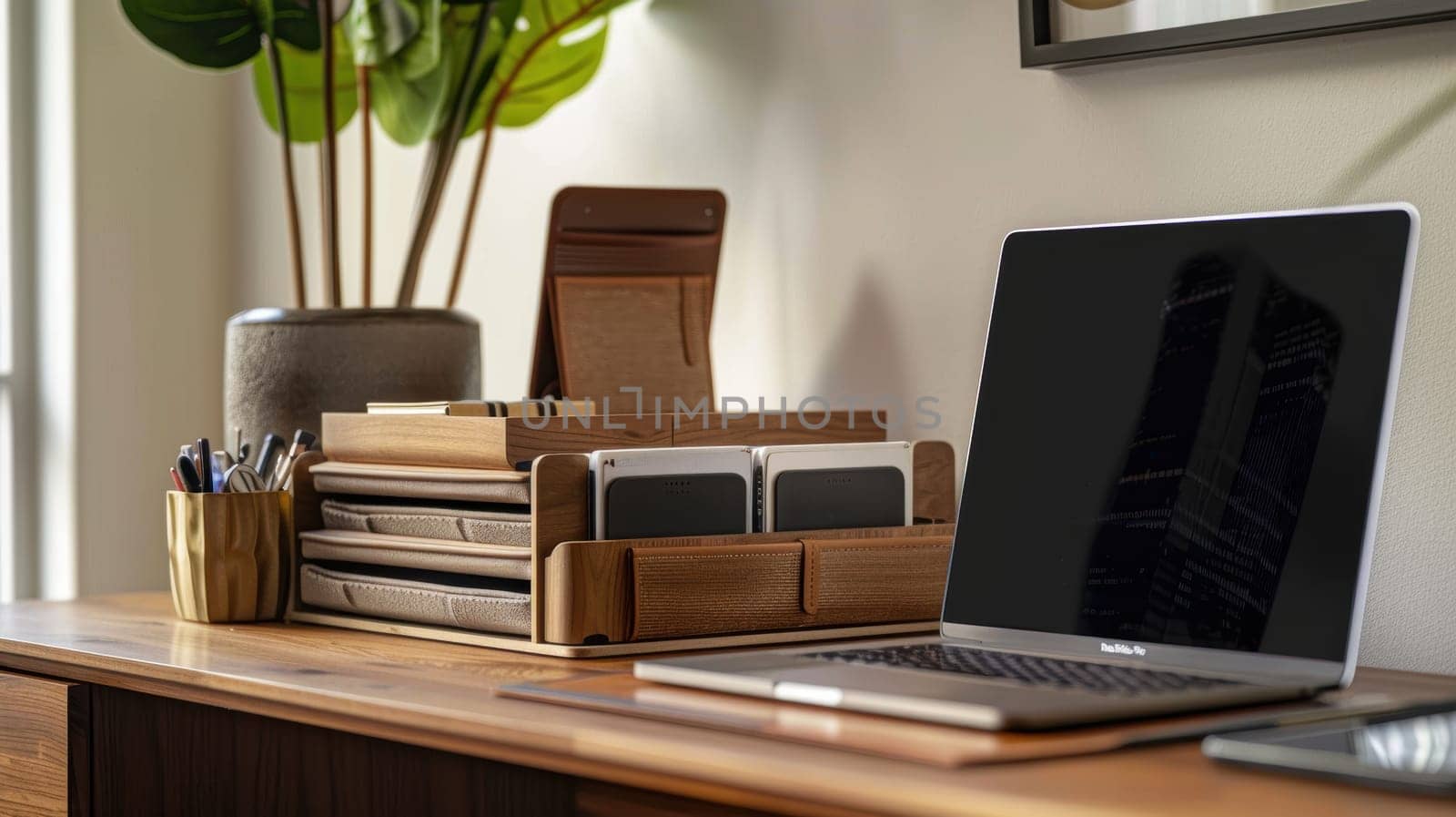 Stylish workspace featuring mocha mousse file organizers and a sleek laptop, set in a contemporary home office environment. a decorative plant adds a touch of greenery, complementing the clean and organized aesthetic.