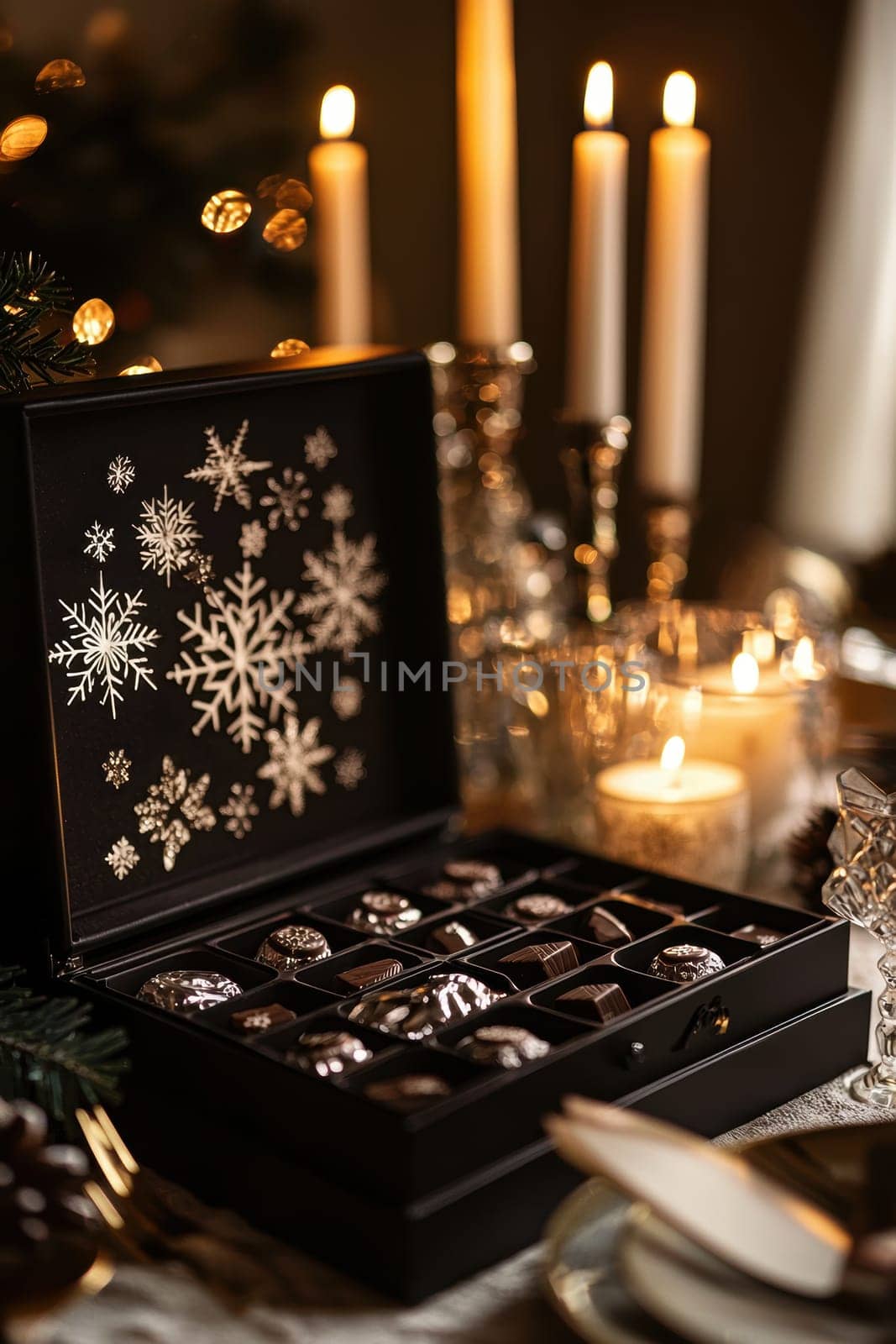 A sophisticated chocolate advent calendar with snowflake-shaped compartments, elegantly displayed on a christmas table adorned with glowing candles and exquisite crystalware, creating a festive and luxurious holiday atmosphere.
