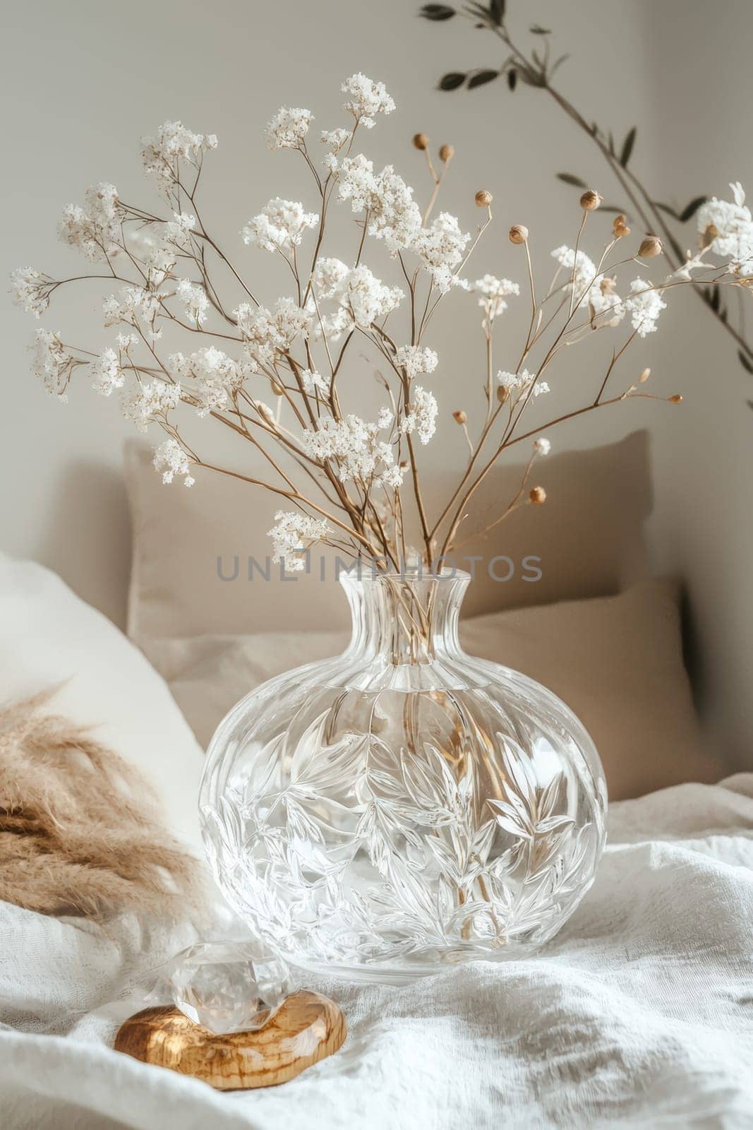 A transparent sticker featuring intricate floral patterns adorns a crystal clear glass vase, surrounded by a serene setting of soft, natural decor. the scene exudes tranquility, with gentle lighting enhancing the floral elegance.