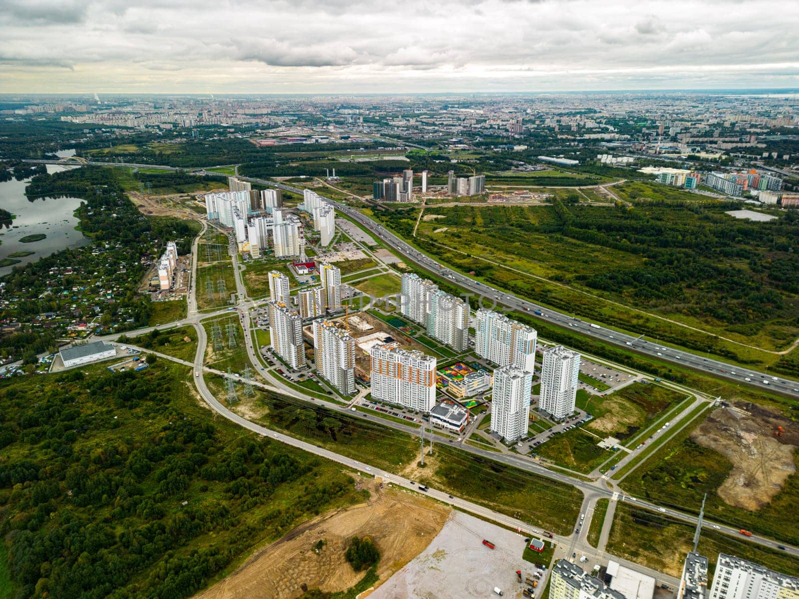 An aerial view showcasing the harmony between modern urban architecture and vibrant natural greenery