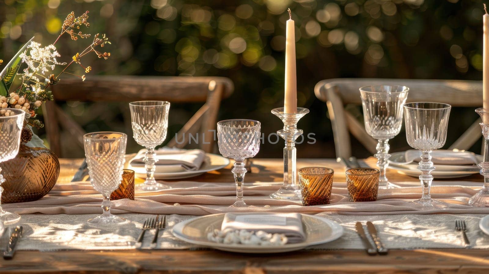 Rustic wedding reception table adorned with mocha mousse runners, elegant crystal glassware, and ambient candle centerpieces. the warm sunset lighting enhances the romantic setting, perfect for a memorable evening celebration.