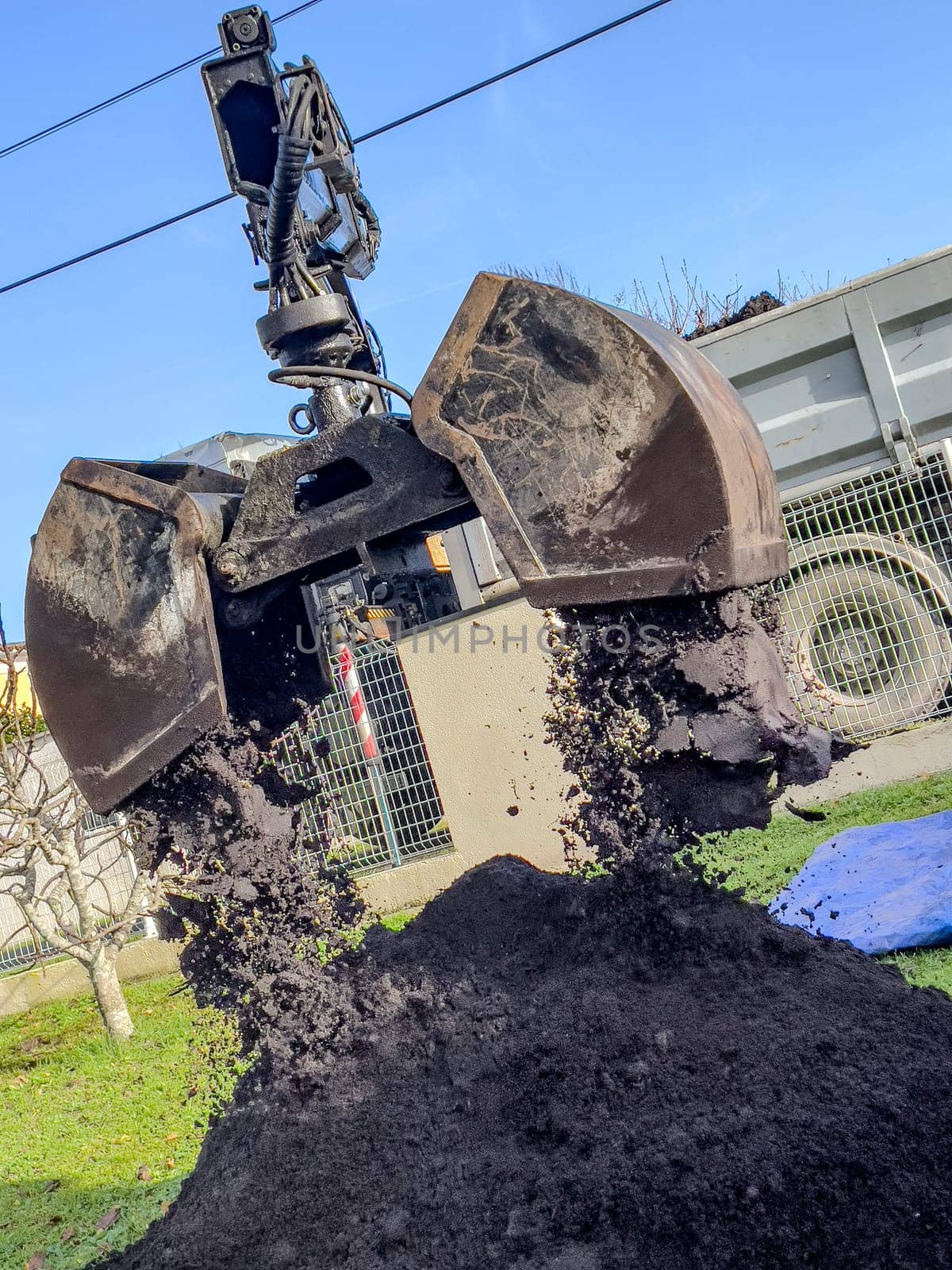 France, Gironde, December 2024, Delivery of topsoil by truck crane to the garden of a residential house. High quality photo