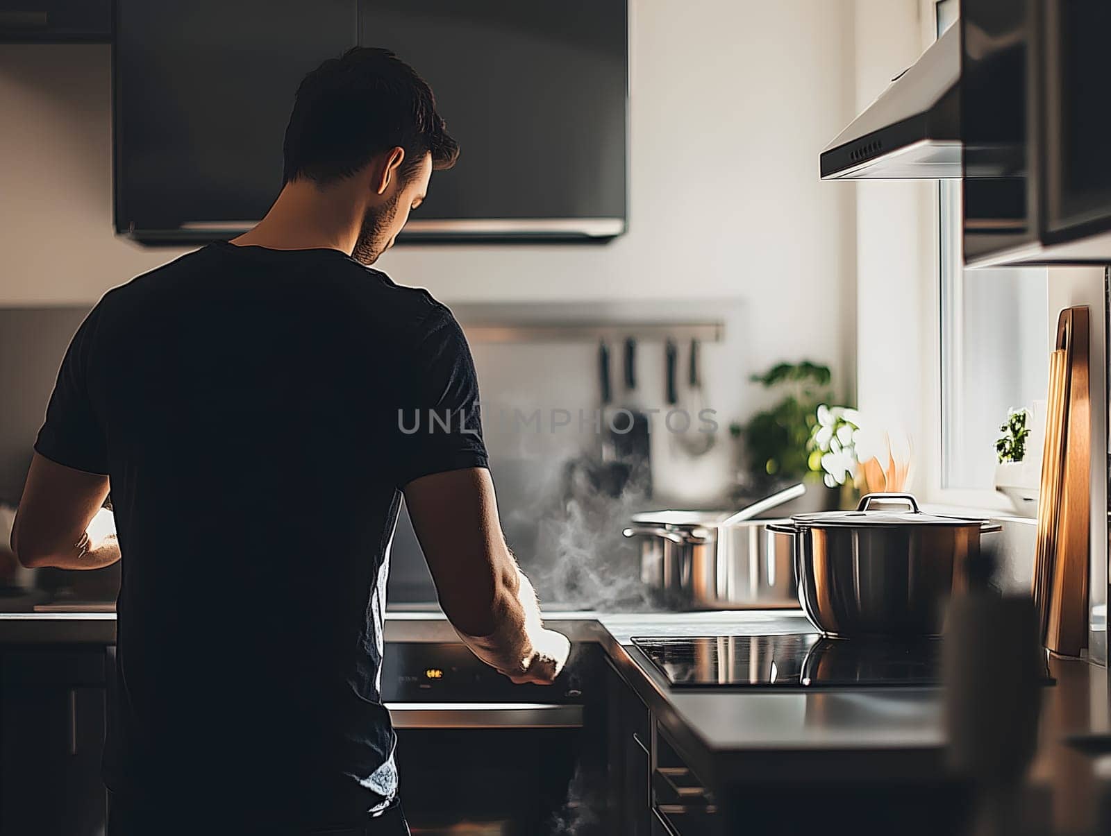 Rear view of a man preparing food in a stylish modern kitchen, with sunlight streaming in through the window and steam rising from pots on the stove, creating a warm, cozy atmosphere.