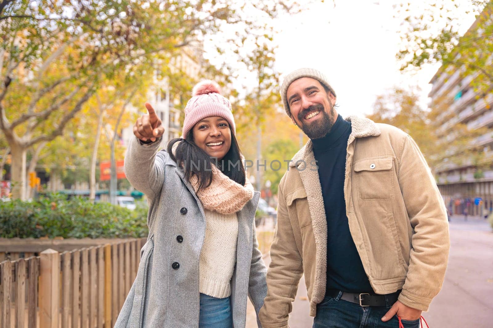 Young traveling couple with bags, look for information about hotels, shopping centers and transportation guides. lifestyle and travel concept.