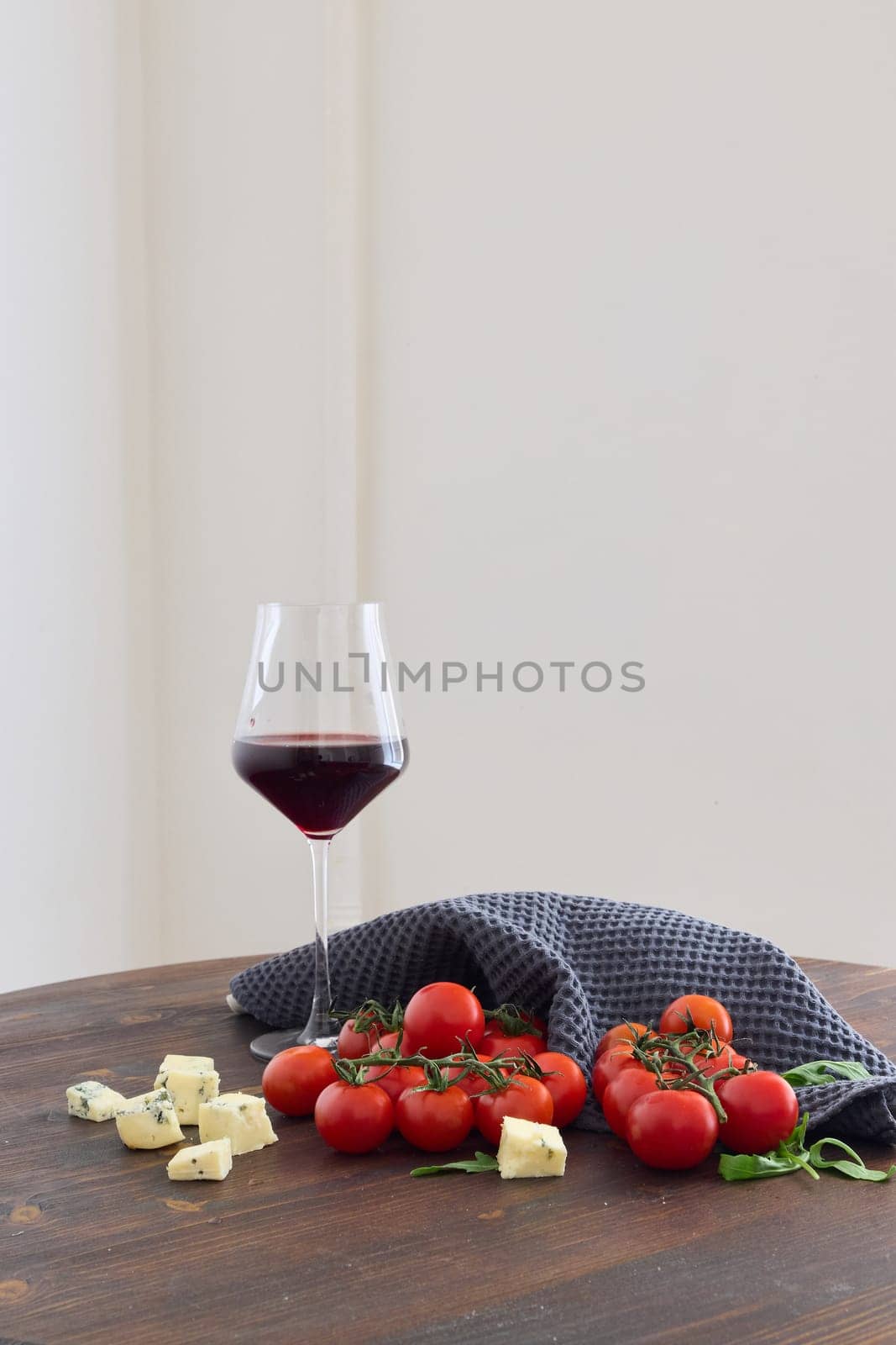 A beautiful mix of ripe tomatoes, creamy cheese, and a glass of red wine creates a lovely ambiance for any occasion