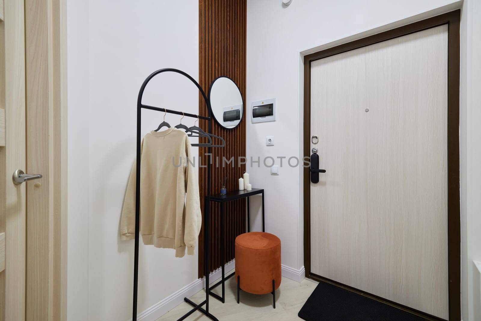 A modern entryway that features stylish decor alongside practical furniture designed for creating a welcoming space