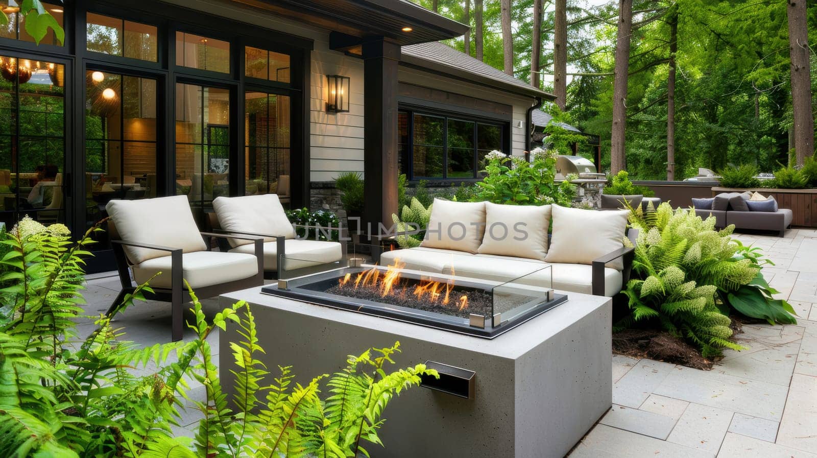 Modern patio featuring mocha-hued sectional furniture with soft cream cushions centered around a fire pit. surrounded by lush greenery, this serene outdoor space blends contemporary design with nature, creating an inviting retreat.