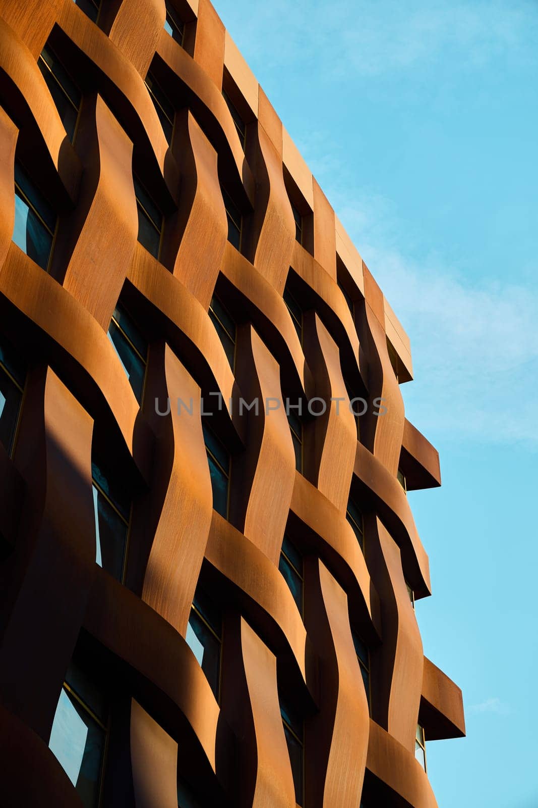 This stunning architectural feature showcases an intricate woven design against a bright blue sky backdrop