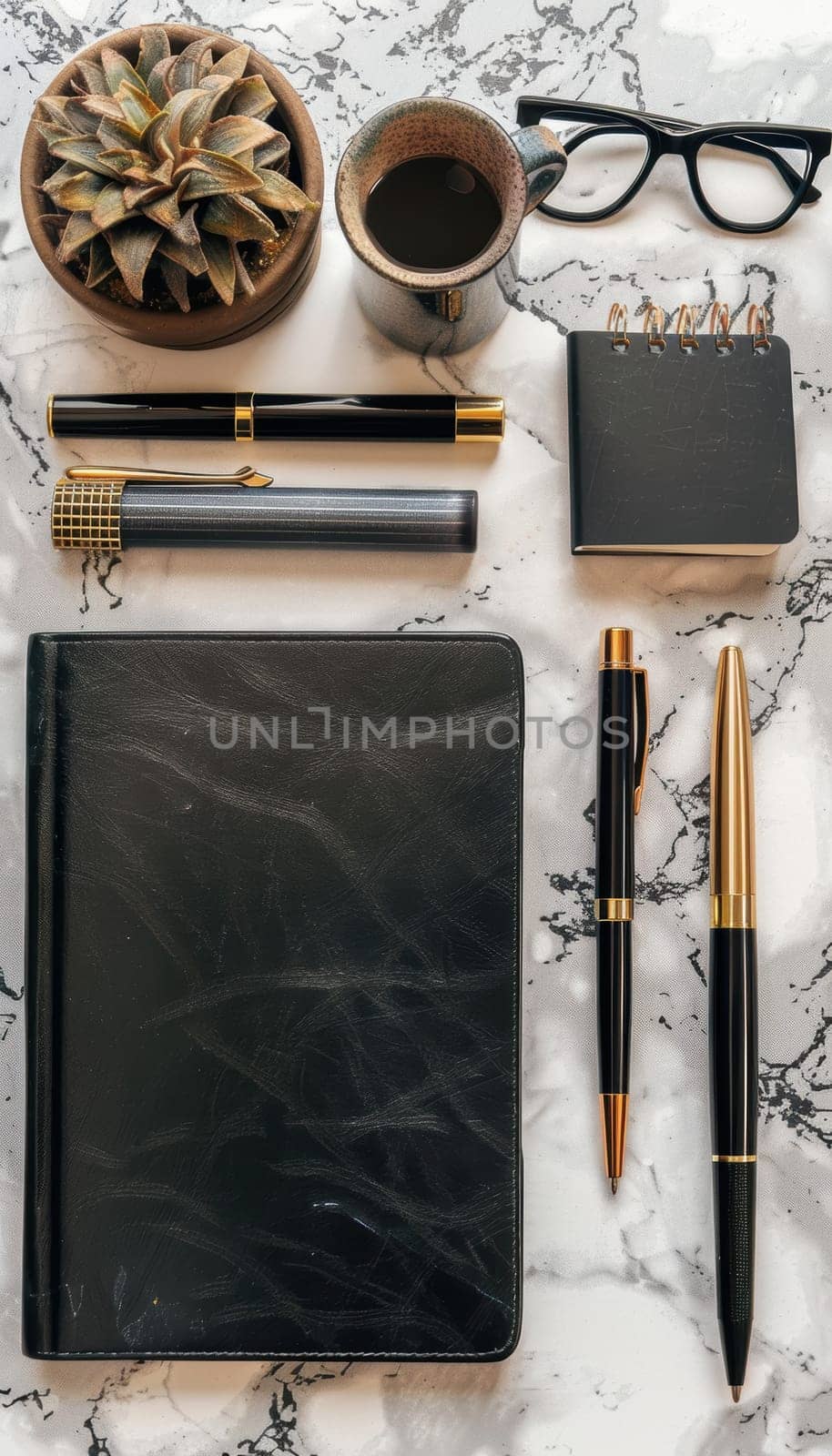 Elegant mocha-colored diaries, planners, and pens are artfully arranged on a luxurious marble surface, complemented by a cup of coffee and delectable chocolates, creating an inspiring setting for productivity and creativity.