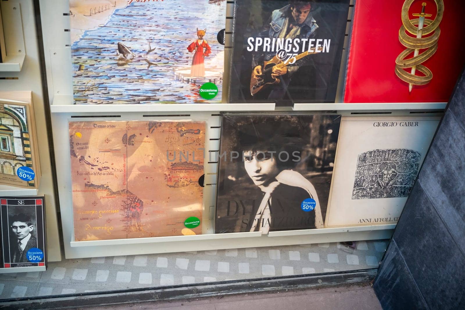 Cremona, Italy - November 27th 2024 Vinyl records featuring bruce springsteen, bob dylan, and other artists, displayed for sale in a shop window in cremona, italy