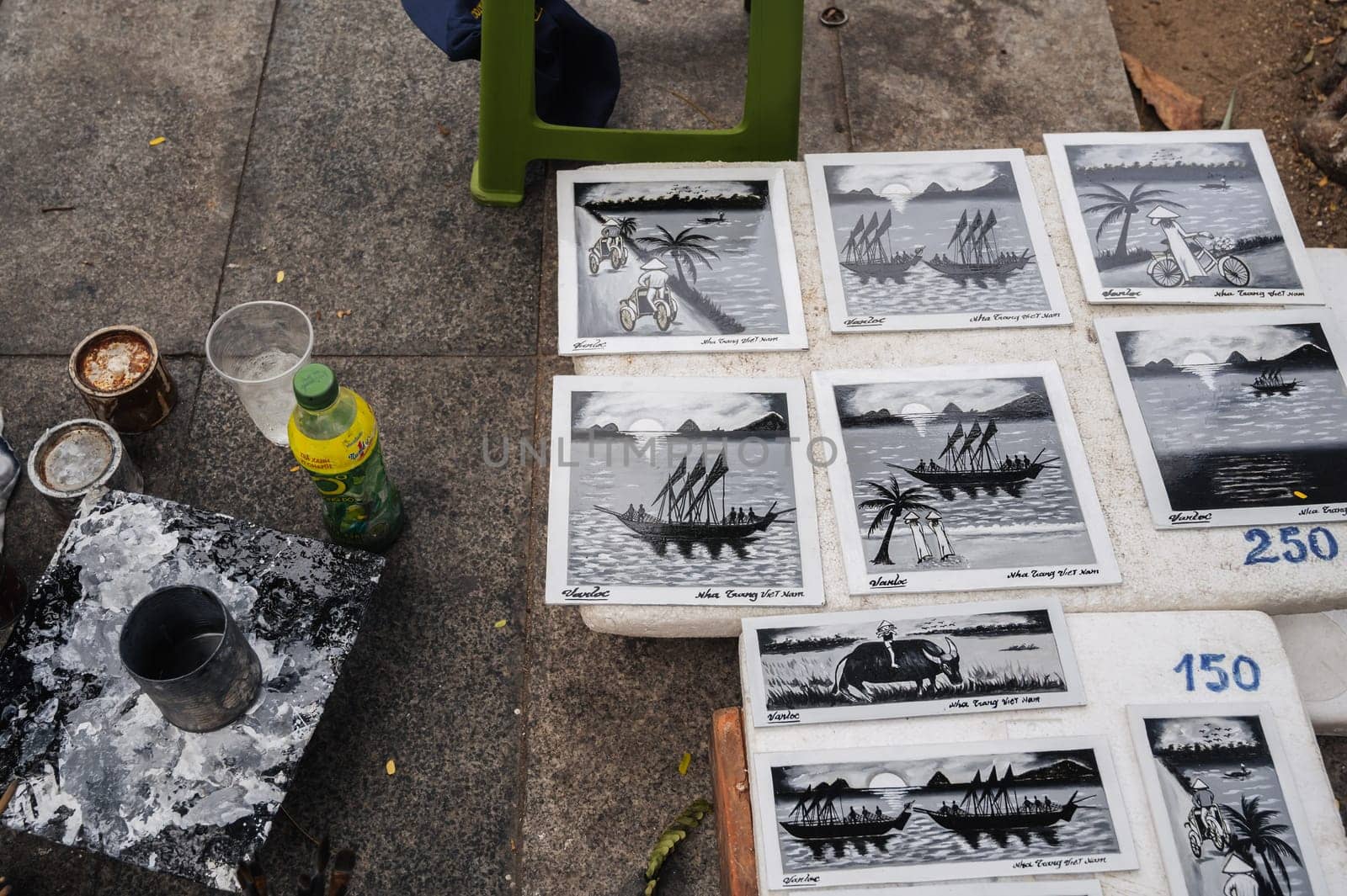 close-up paintings depicting an Asian traditional scene from life. Painted ships, palm trees and women in traditional Vietnamese hats. Nha Trang, Vietnam - July 25, 2024