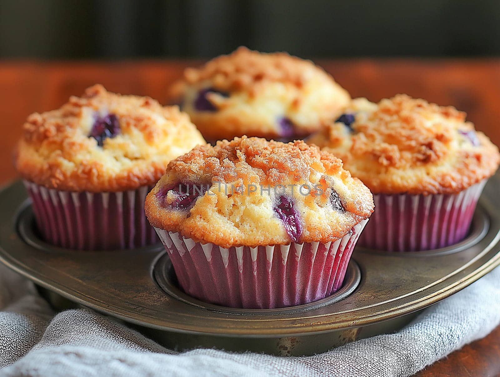Delicious blueberry muffins, topped with crumble, are displayed on a vintage tray. A perfect treat.