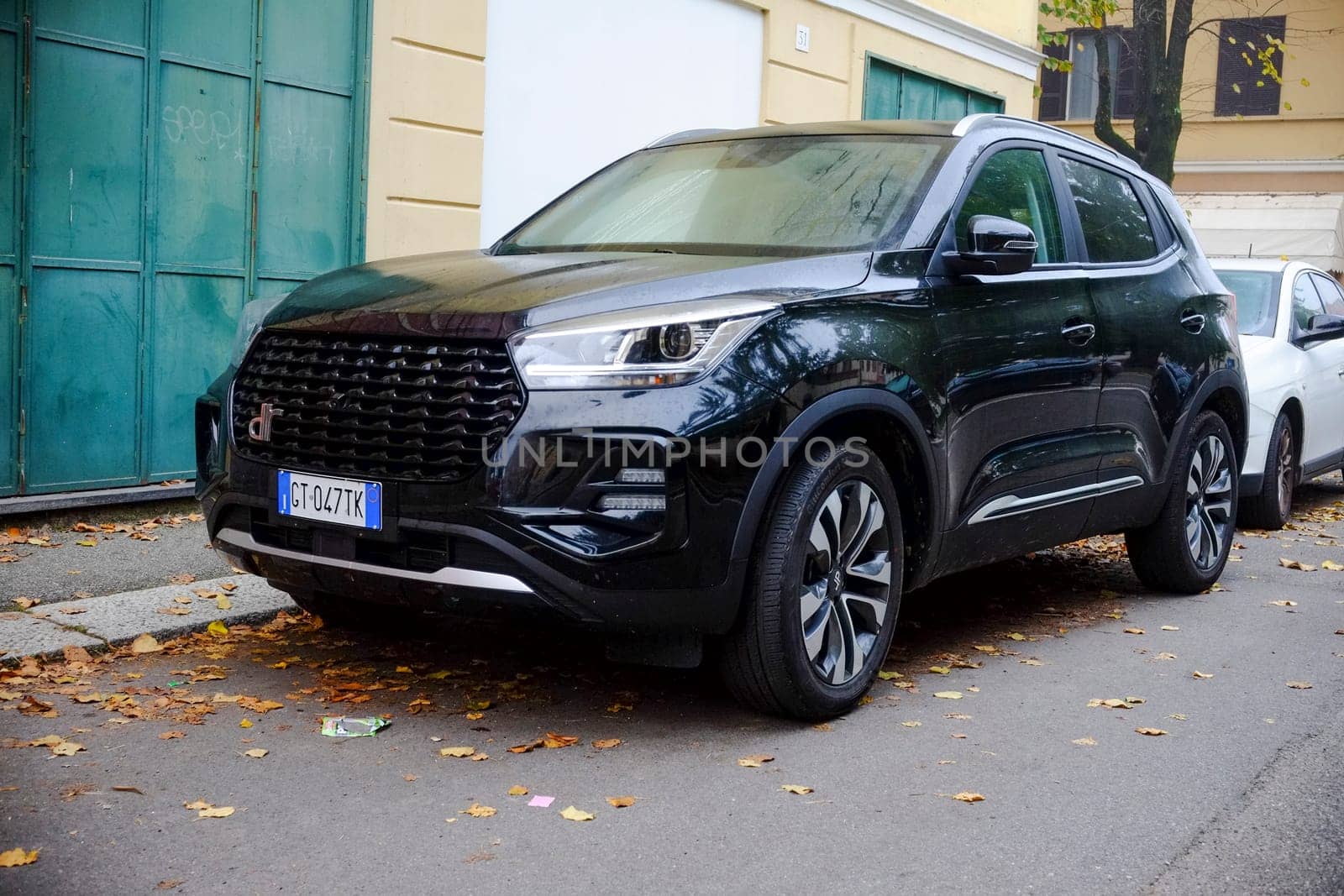 Cremona, Itally - October 6th 2024 A modern black dr 5.0 car parked elegantly in a bustling city street during autumn, exuding power and innovation with its sleek design and luxury appeal