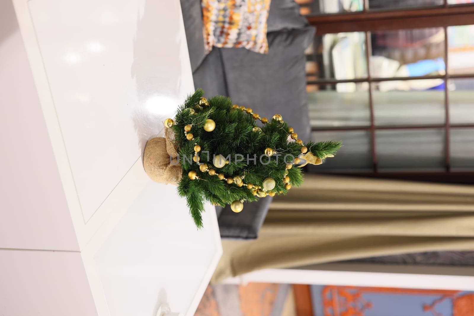 A beautifully charming mini Christmas tree adorned with stunning golden ornaments, perfect for enhancing holiday decor