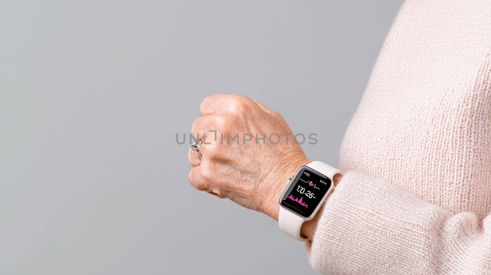 A Senior hands holding smart watch displaying health metrics, showcasing technology and wellness