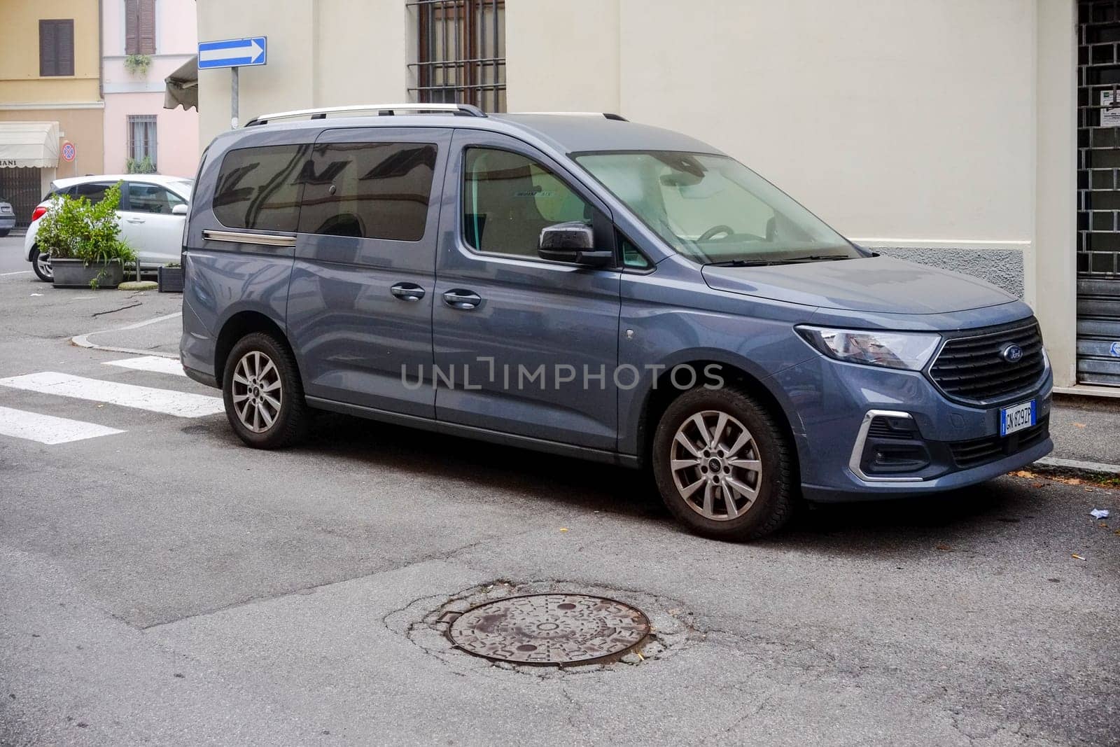 Cremona, Itally - October 6th 2024 New ford tourneo connect titanium 1.5 ecoblue parked on the side of the street with a pedestrian crossing in the background
