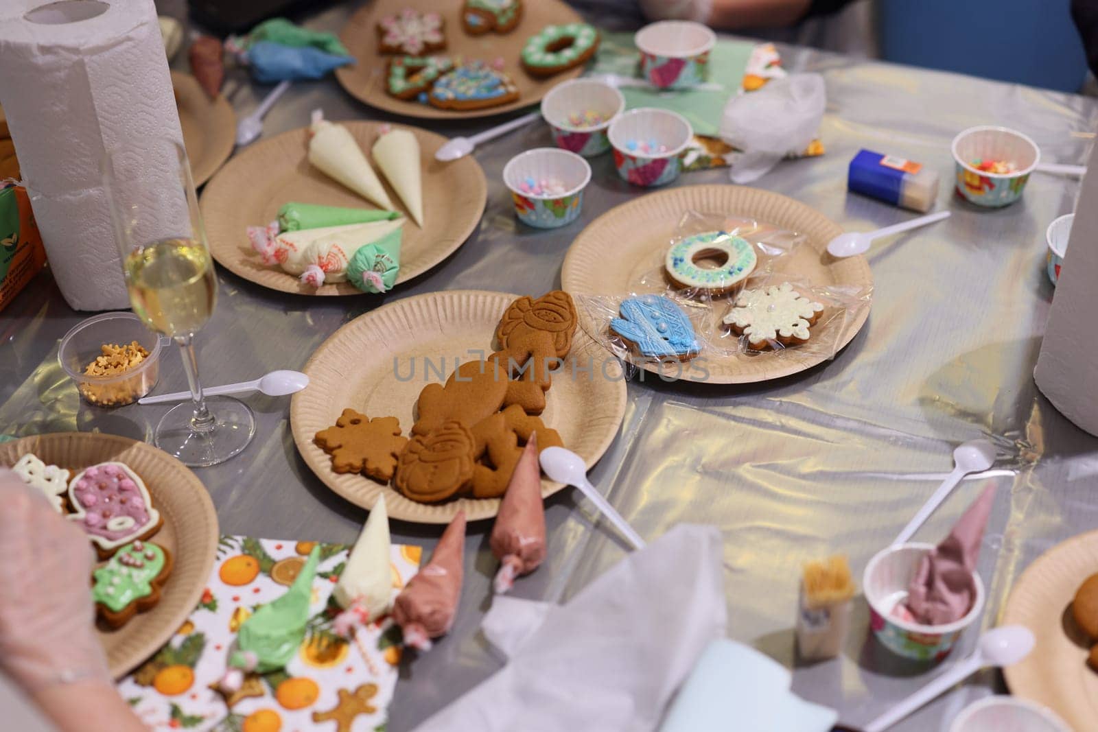 A lively gathering focused on the joyful activity of decorating cookies with various icings and toppings