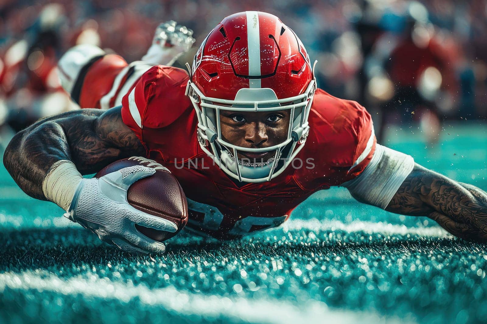 A Diving football player in red uniform reaching for touchdown on field, showcasing determination and athleticism