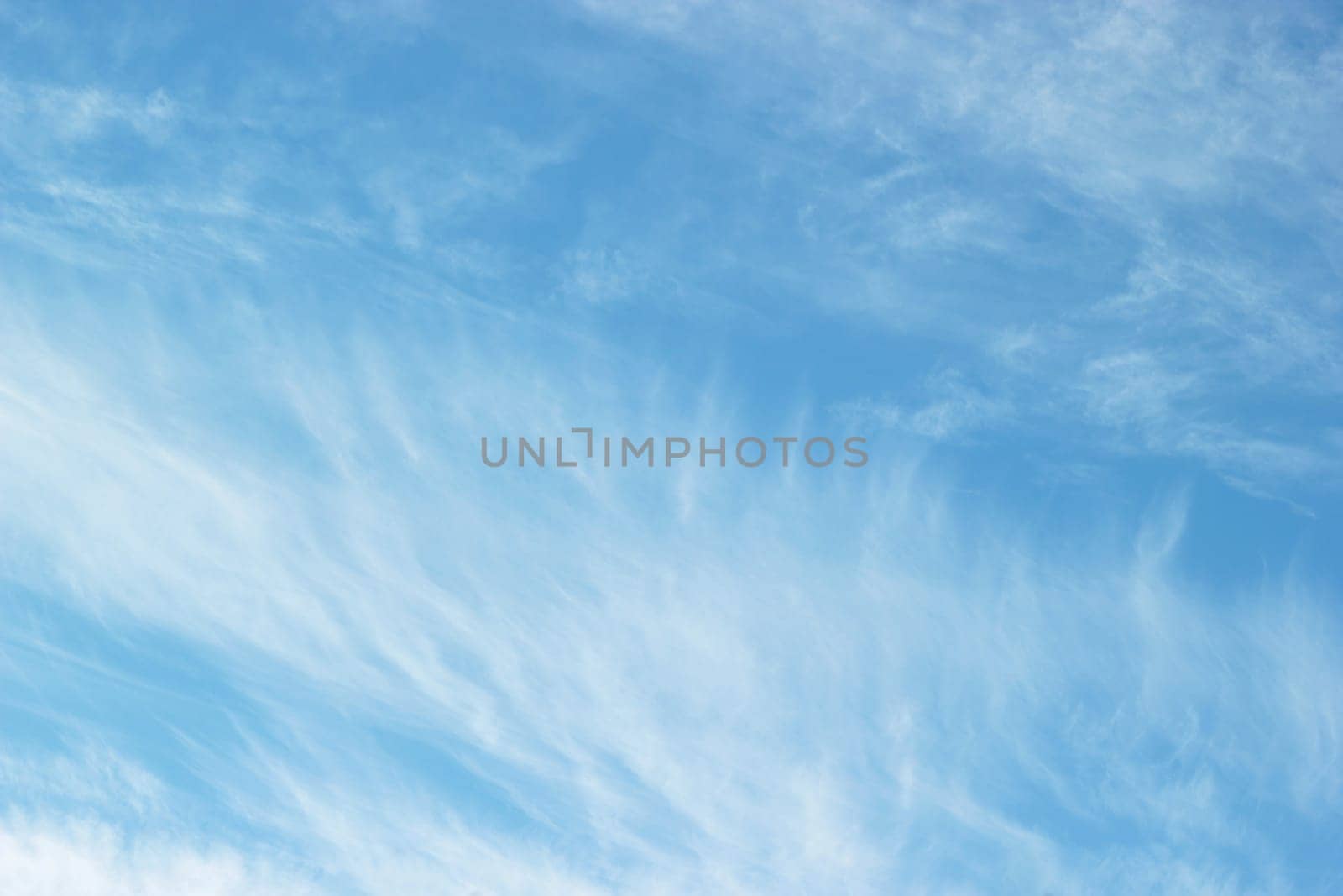 Uniform background of blue sky and cirrus cloud patterns.