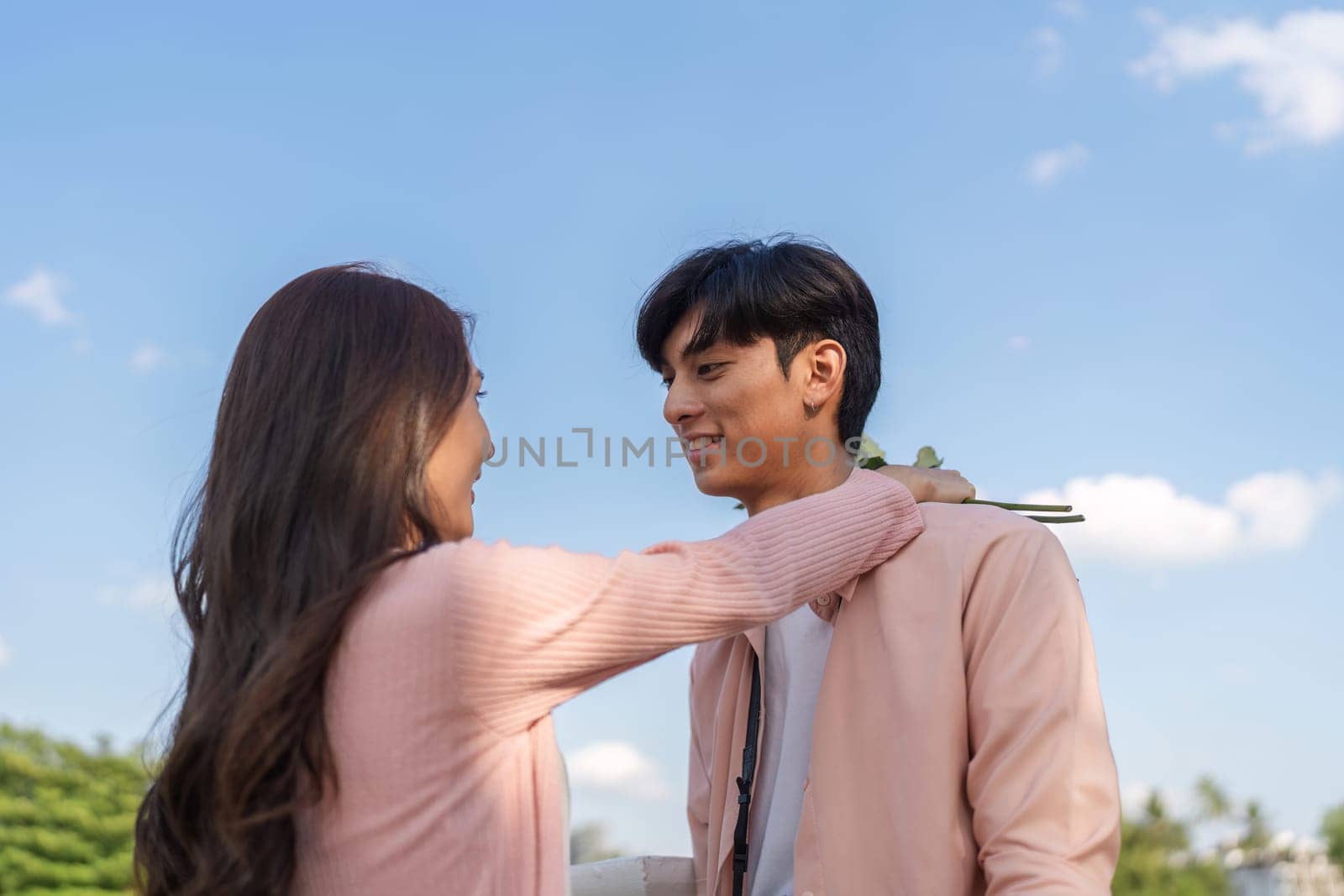 A couple shares a tender moment embodying love and romance in a picturesque outdoor setting.