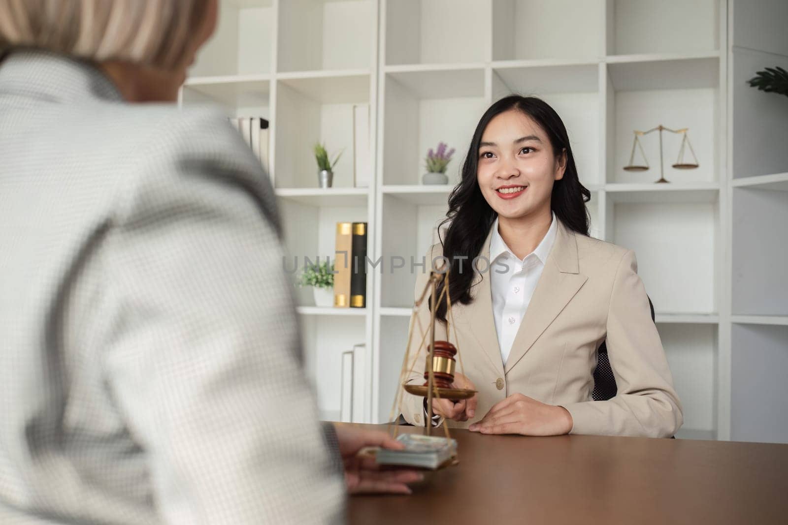 A woman receives legal guidance during a consultation highlighting the importance of law in business decision-making.