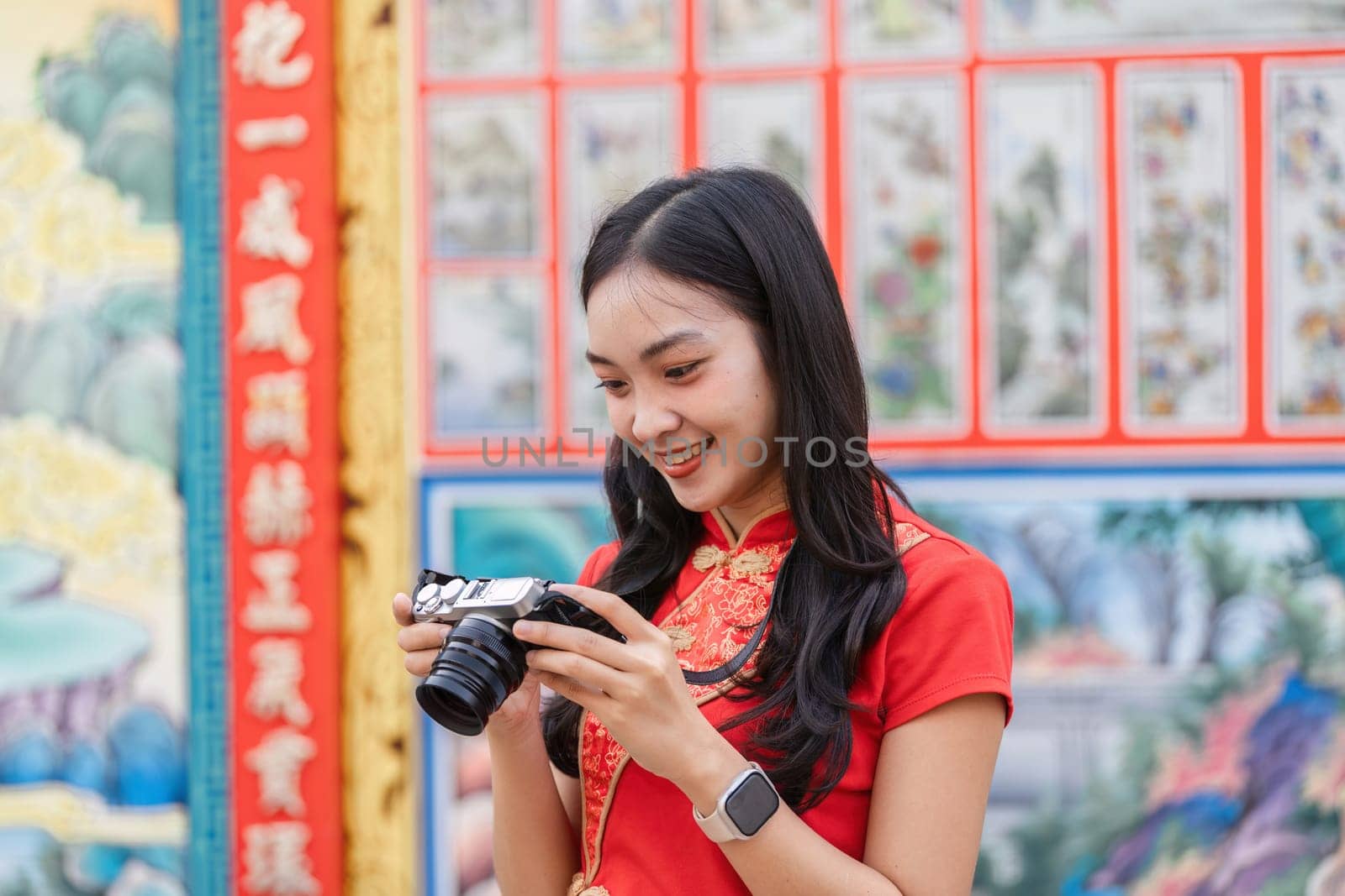 A tourist enjoys capturing memorable moments during the lively Chinese New Year celebrations.