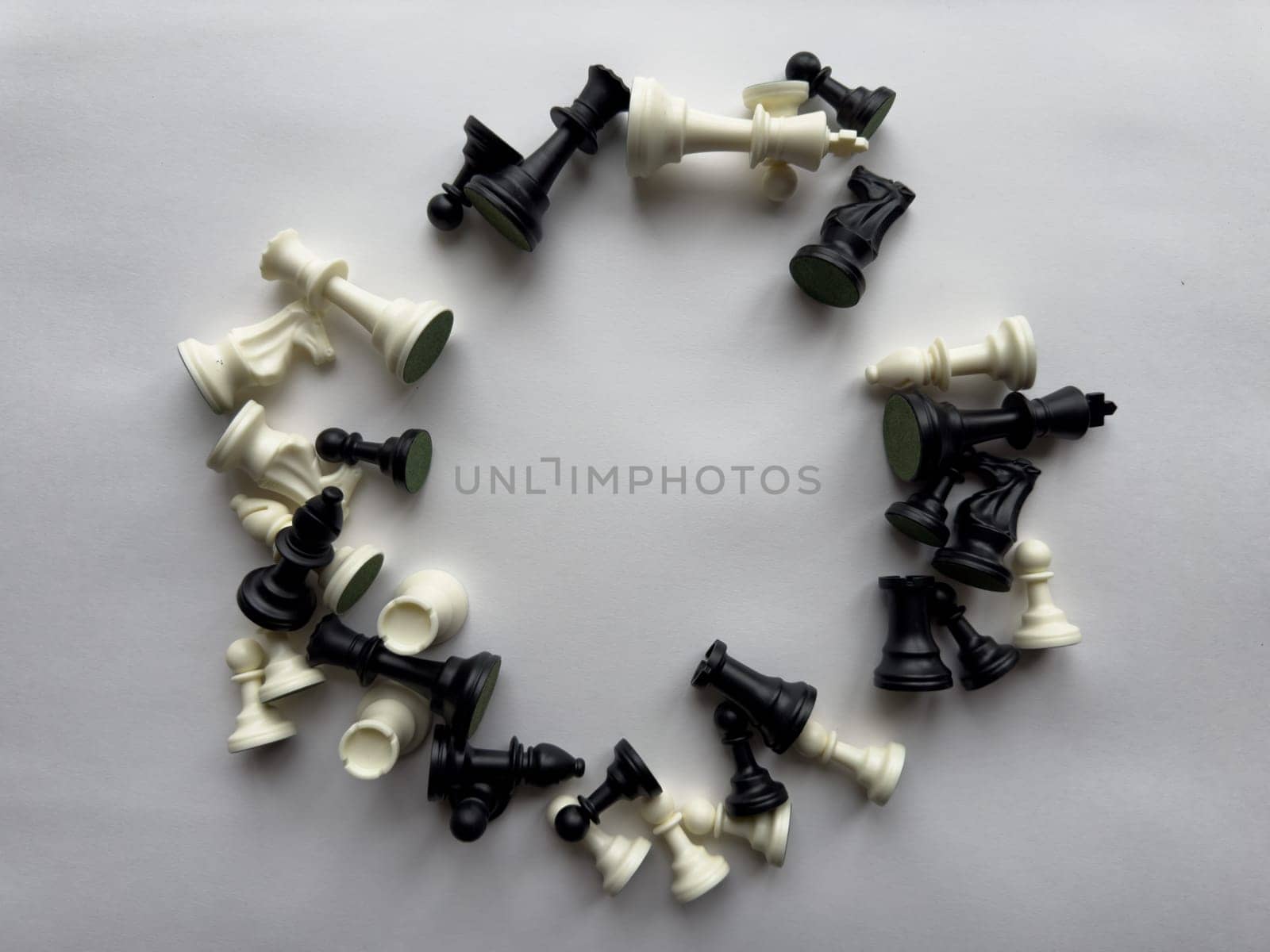Circular arrangement of chess pieces on white background.