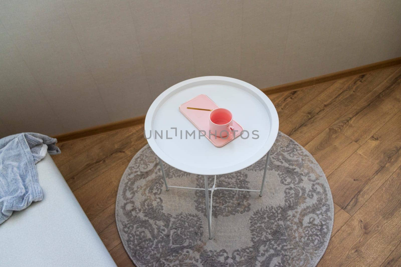 Coffee table with the pink cup for ladies on it