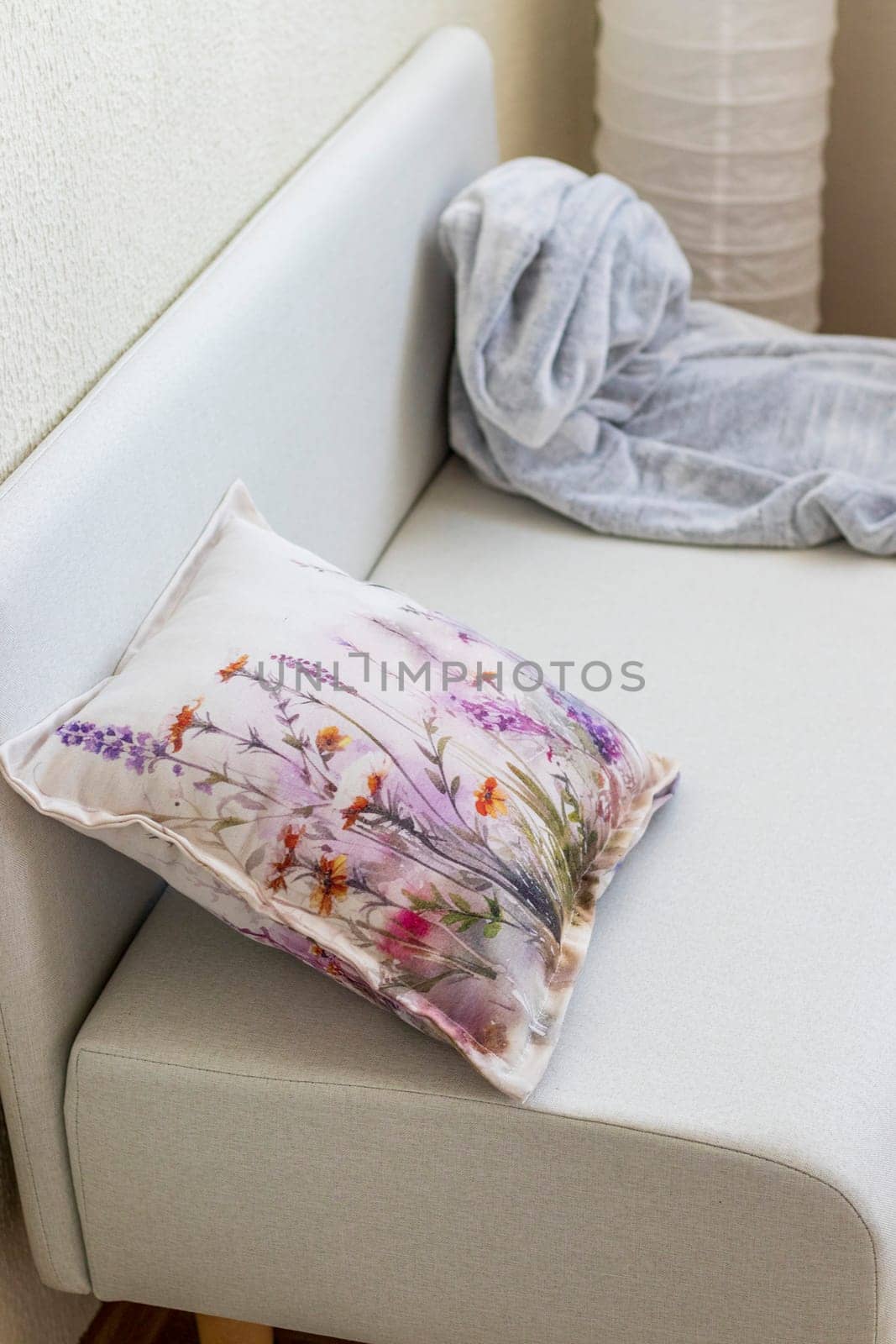 Decorative cushion and plaid on the sofa