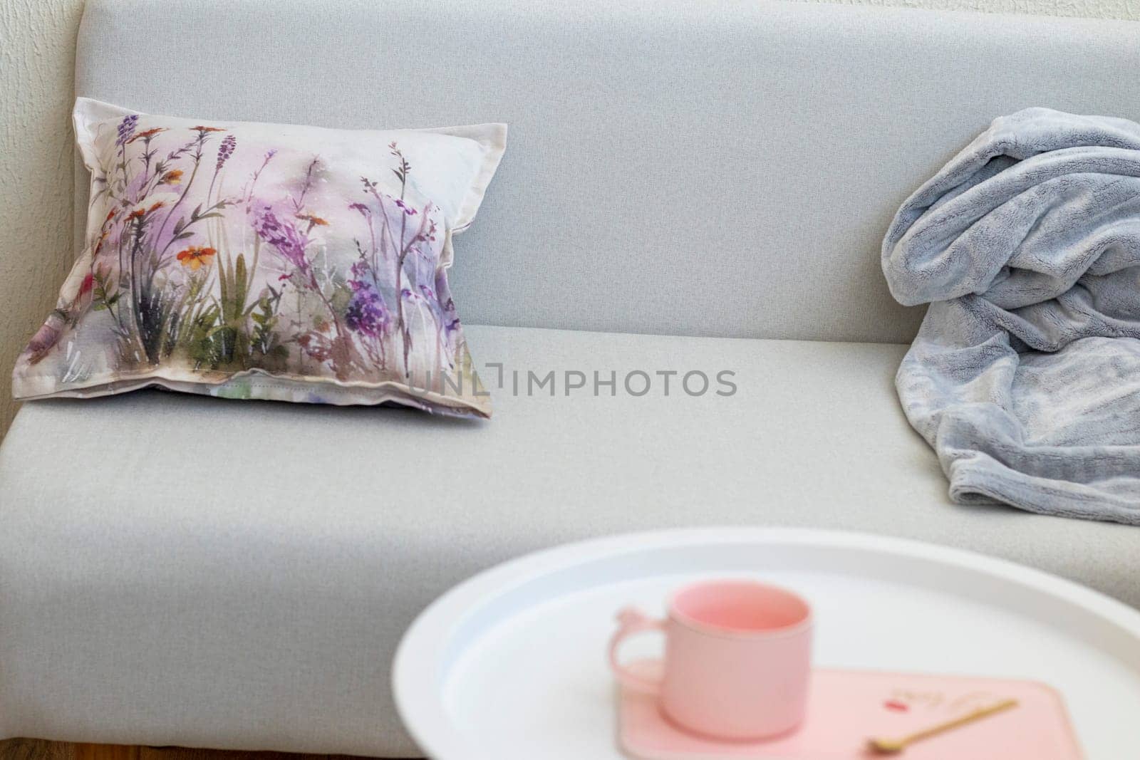 Decorative cushion and plaid on the sofa