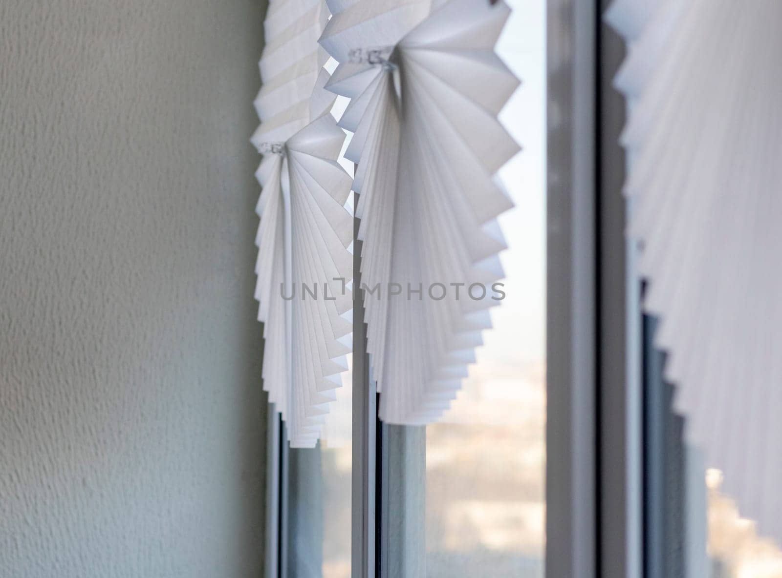 Paper blinds on the window in the balcony of the apartment