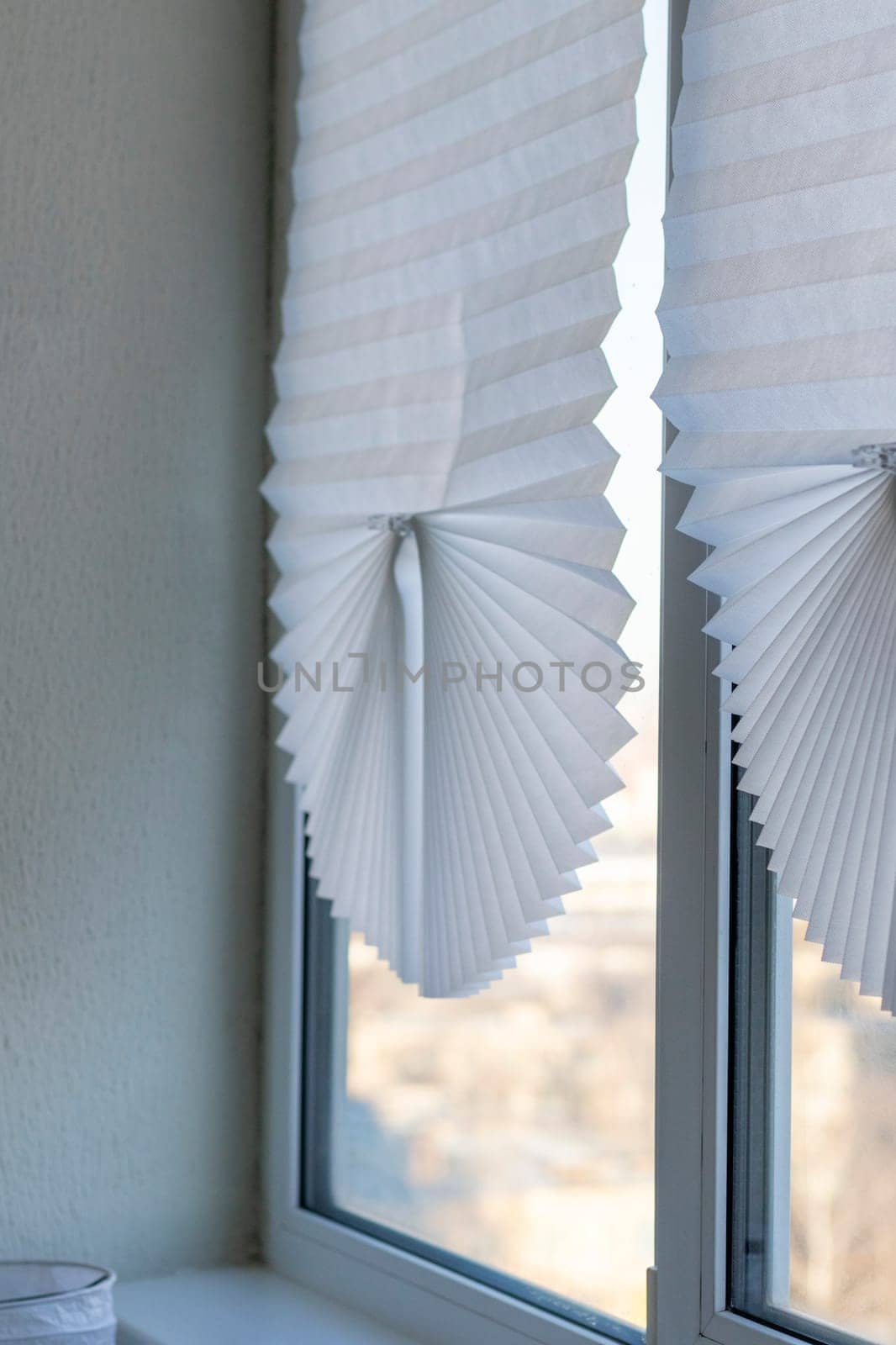 Paper blinds on the window in the balcony of the apartment