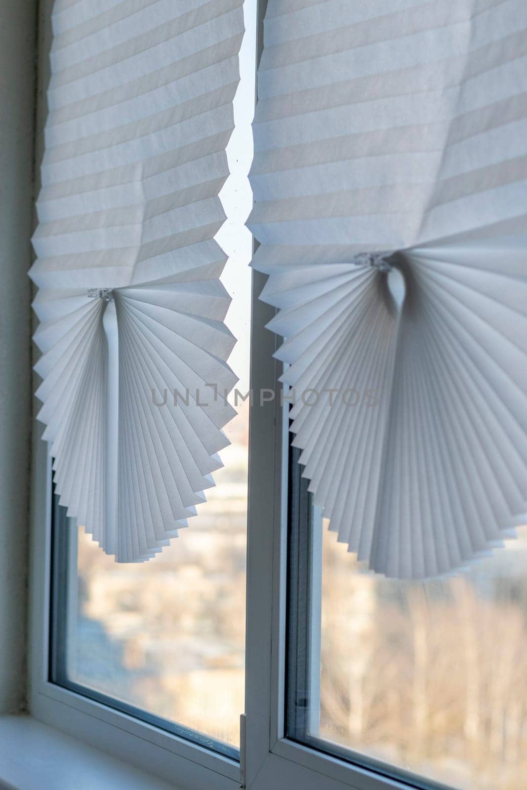 Paper blinds on the window in the balcony of the apartment