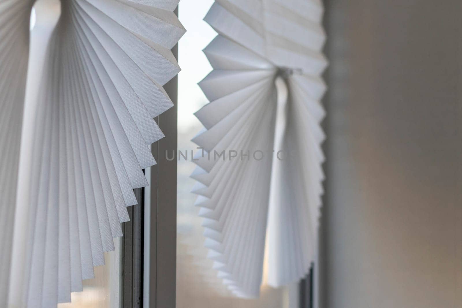 Paper blinds on the window in the balcony of the apartment